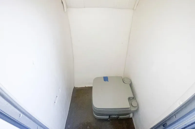Slide: The Image of Compact bathroom with portable toilet in 2000 Baja 36 Outlaw boat. - 51