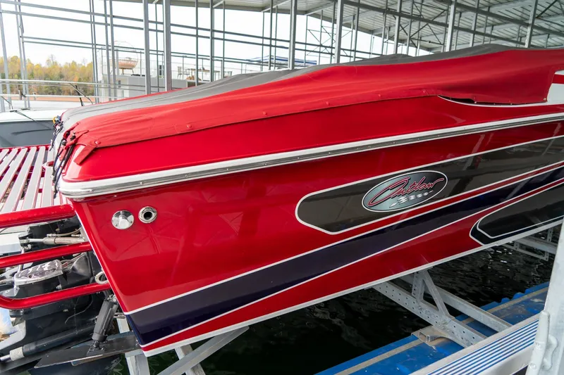 Slide: The Image of Red 2000 Baja 36 Outlaw boat docked in a marina, side view. - 8
