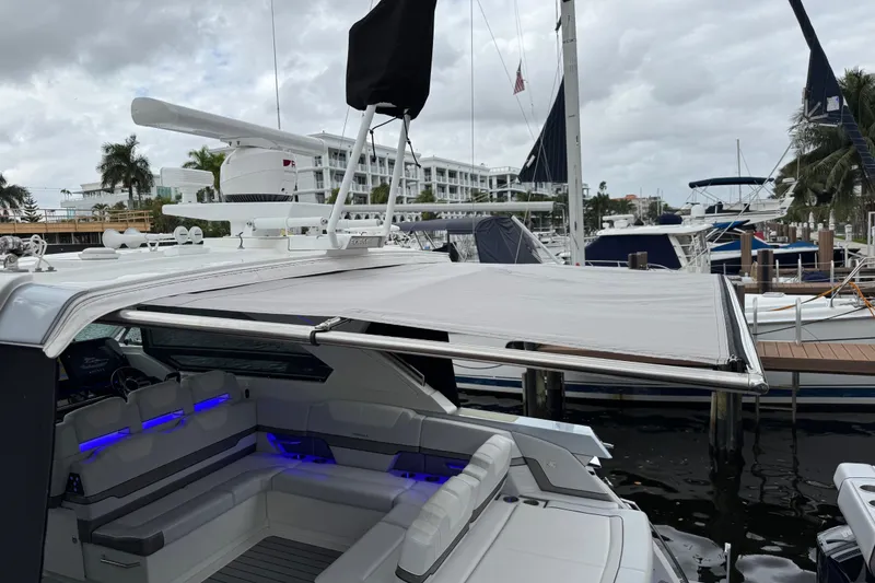 Slide: The Image of 2023 Formula 400 Super Sport Crossover yacht with extended canopy at marina. - 10