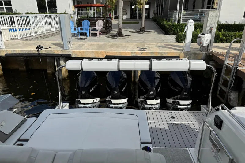 Slide: The Image of 2023 Formula 400 Super Sport Crossover with four Mercury outboard engines docked. - 14