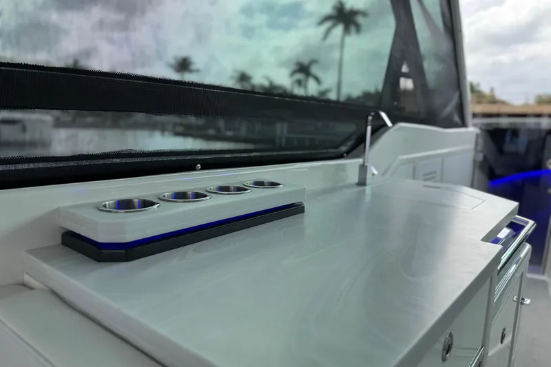 Slide: The Image of 2023 Formula 400 Super Sport Crossover boat interior with sleek countertop and cup holders. - 23