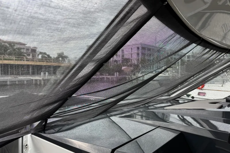 Slide: The Image of 2023 Formula 400 Super Sport Crossover with mesh canopy, docked near waterfront buildings. - 25