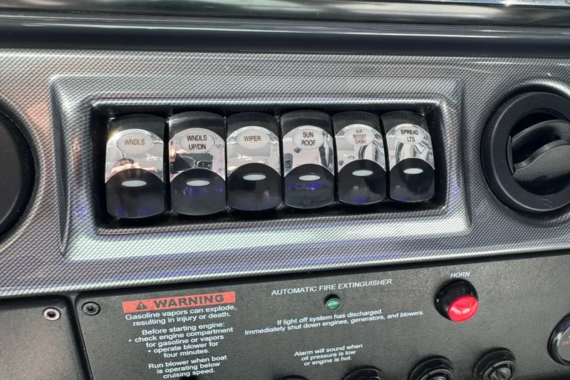 Slide: The Image of Control panel of 2023 Formula 400 Super Sport Crossover with labeled switches and warning labels. - 37