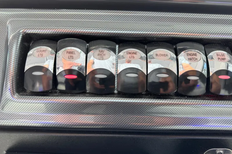 Slide: The Image of Control panel switches on a 2023 Formula 400 Super Sport Crossover boat. - 39