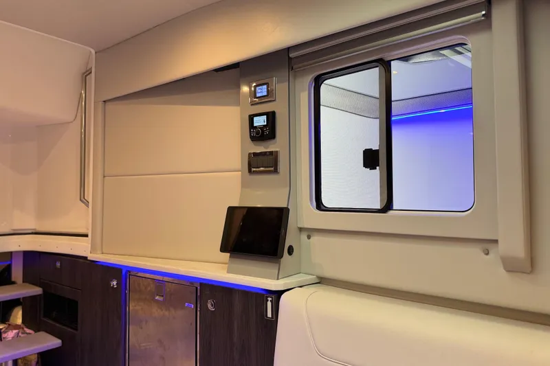 Slide: The Image of Interior of 2023 Formula 400 Super Sport Crossover with modern controls and ambient lighting. - 60