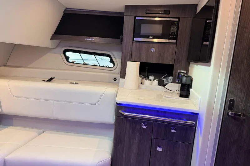Slide: The Image of 2023 Formula 400 Super Sport Crossover interior with kitchenette and seating area. - 62