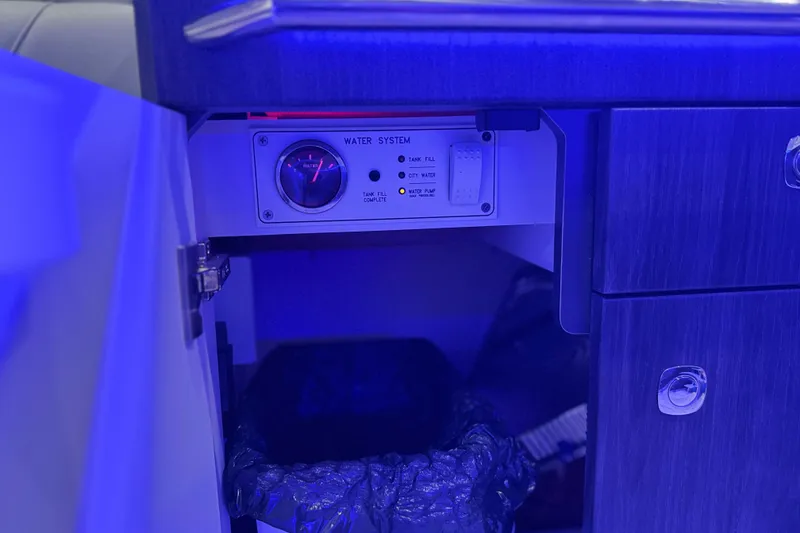 Slide: The Image of 2023 Formula 400 Super Sport Crossover water system control panel in blue lighting. - 65