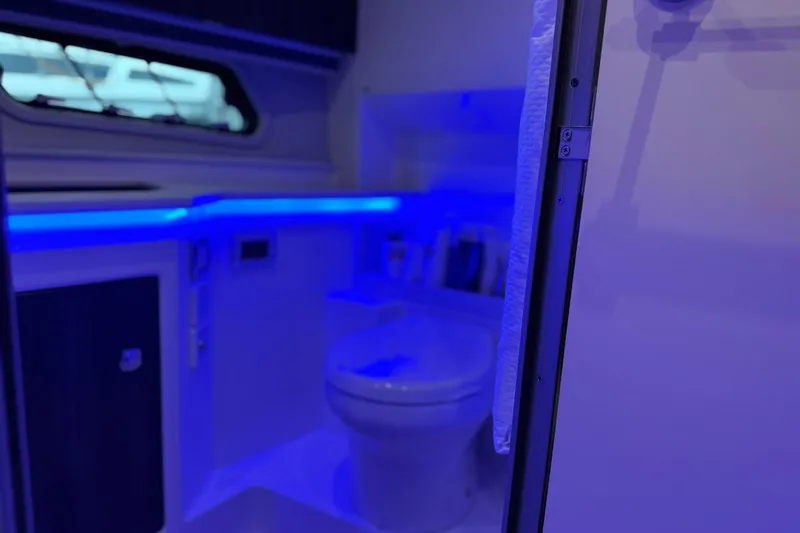 Slide: The Image of 2023 Formula 400 Super Sport Crossover bathroom with blue ambient lighting. - 68