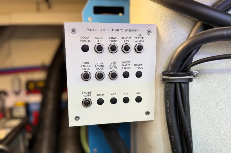 Slide: The Image of Control panel on 2023 Formula 400 Super Sport Crossover boat, featuring various system switches. - 80