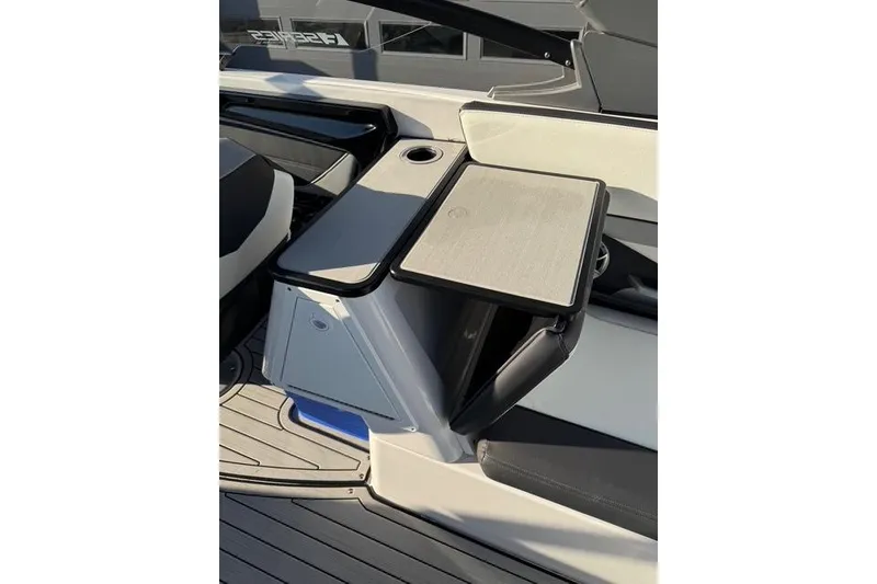 Slide: The Image of 2021 Yamaha Boats 252SE interior with sleek seating and table design. - 16
