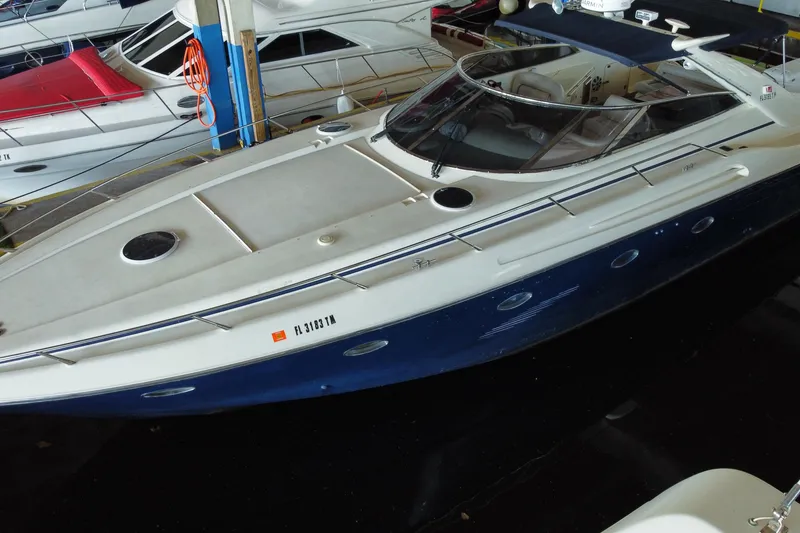 The Image of 1997 Sunseeker Camargue 51 yacht docked in a marina, featuring sleek design and blue hull. - 0