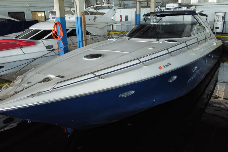 Slide: The Image of 1997 Sunseeker Camargue 51 yacht docked in a marina, showcasing sleek design. - 13