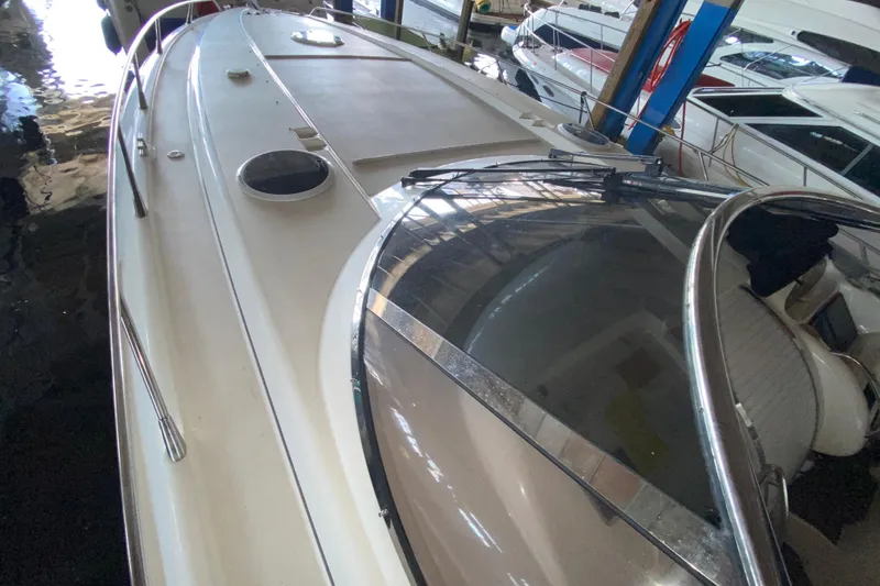 Slide: The Image of 1997 Sunseeker Camargue 51 yacht docked indoors, showcasing sleek design and spacious deck. - 19
