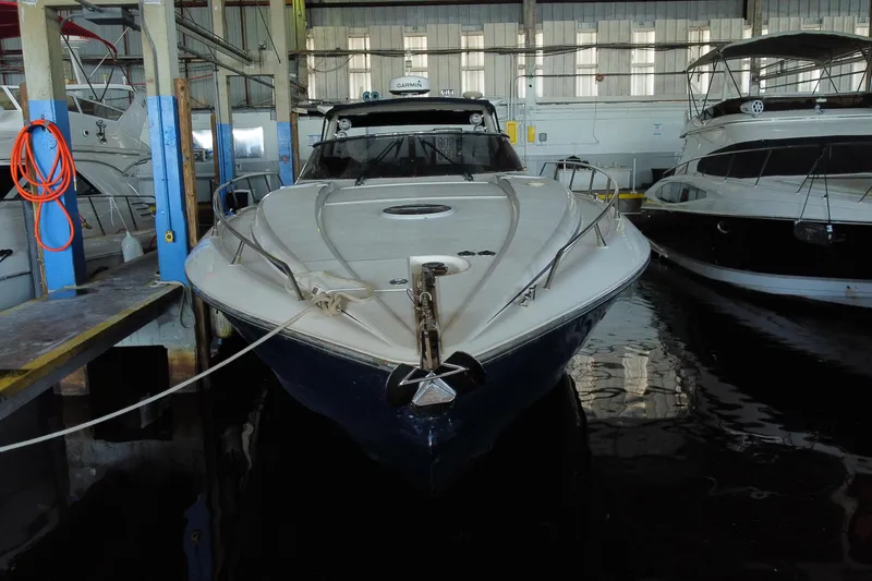 Slide: The Image of 1997 Sunseeker Camargue 51 yacht docked in a marina, front view. - 2