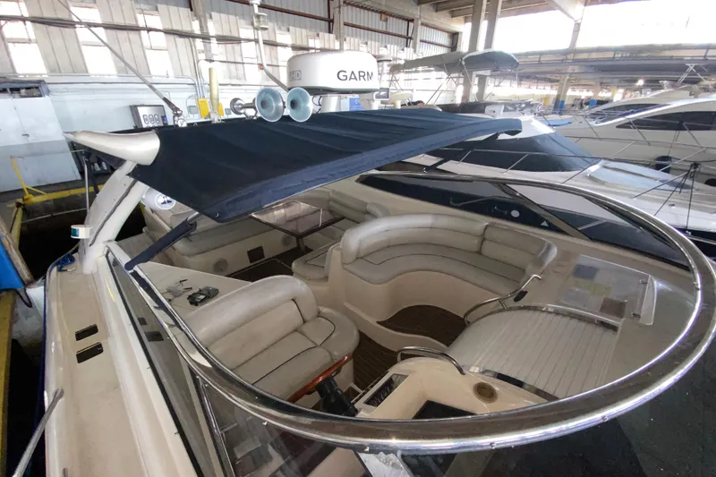 Slide: The Image of 1997 Sunseeker Camargue 51 yacht interior with seating and canopy in a marina setting. - 21