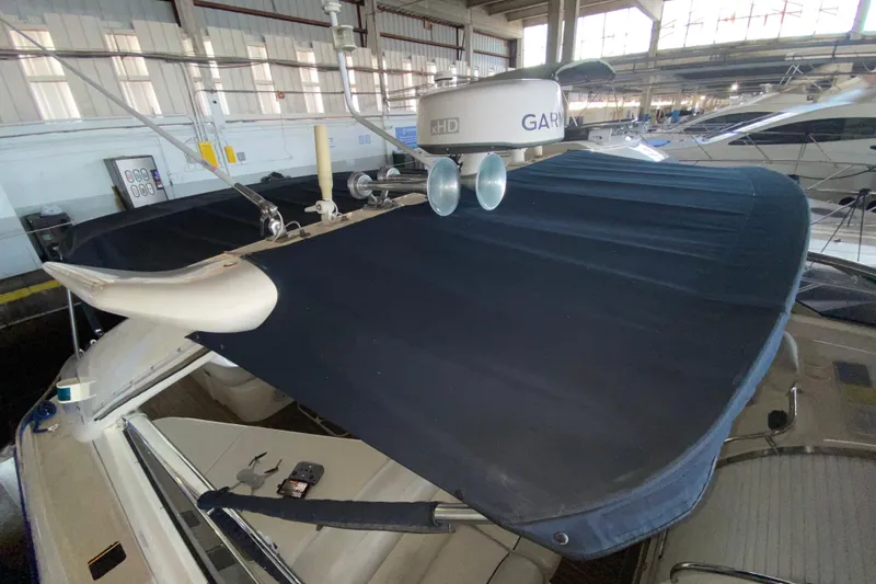 Slide: The Image of 1997 Sunseeker Camargue 51 yacht with radar equipment and blue canopy in a marina. - 22