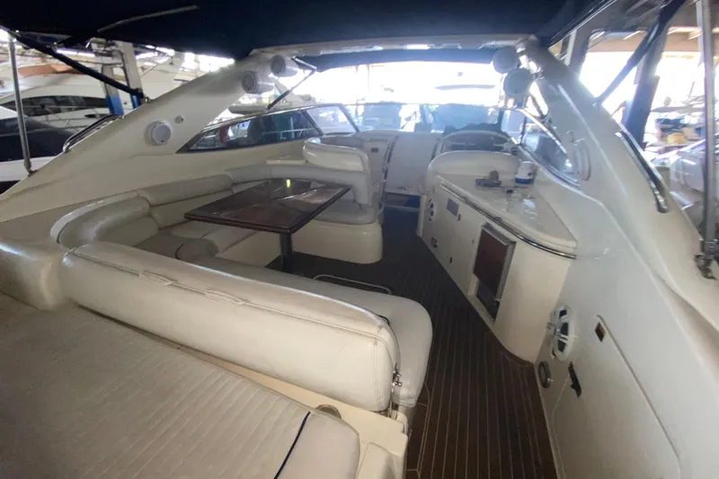 Slide: The Image of Interior of 1997 Sunseeker Camargue 51 yacht with white seating and wooden table. - 25