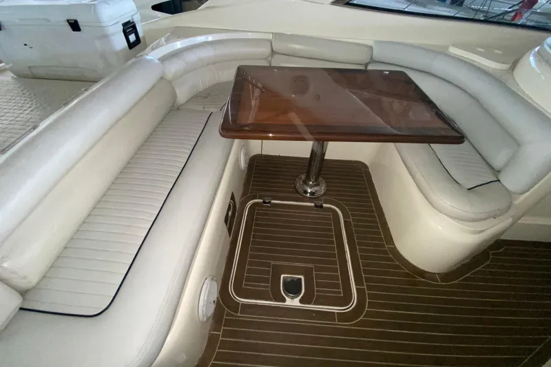 Slide: The Image of 1997 Sunseeker Camargue 51 yacht interior with white seating and wooden table. - 26