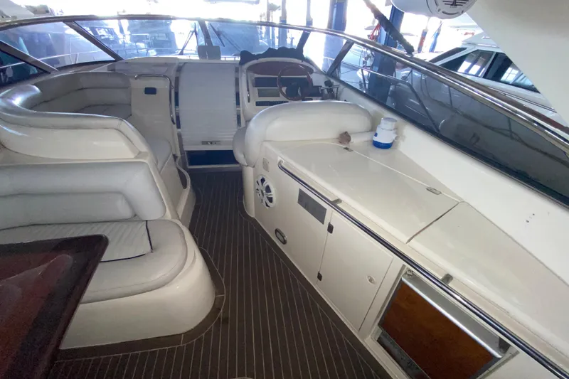 Slide: The Image of Interior of 1997 Sunseeker Camargue 51 yacht with white seating and wooden flooring. - 28
