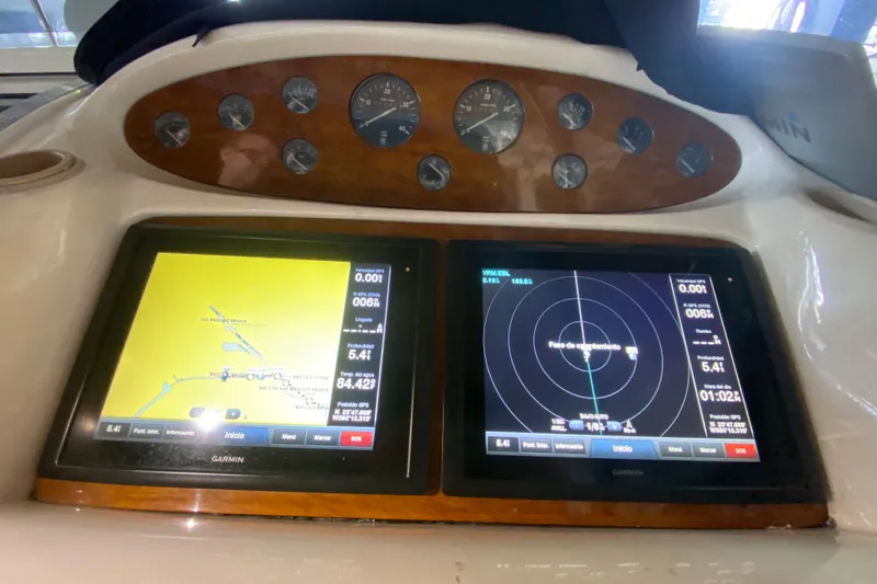 Slide: The Image of 1997 Sunseeker Camargue 51 dashboard with navigation and radar displays. - 36