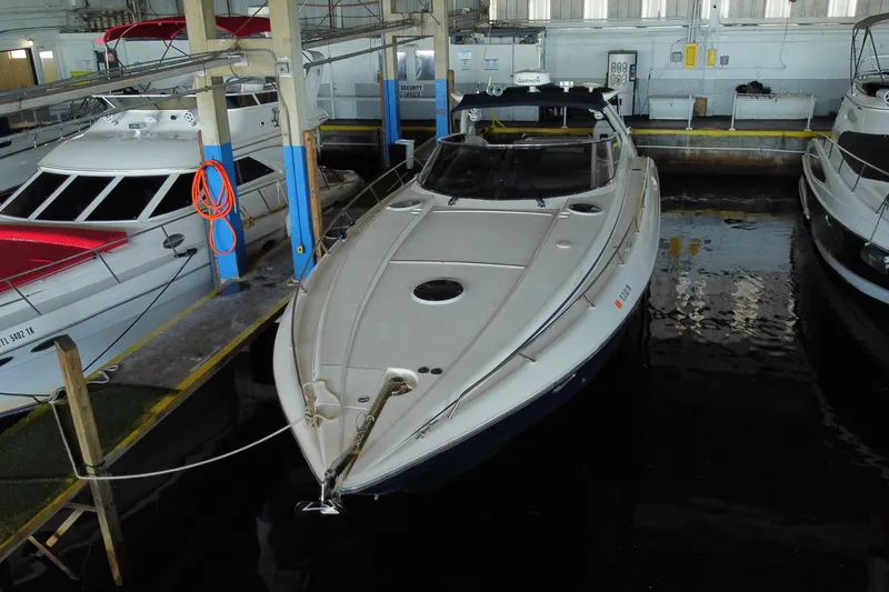 Slide: The Image of 1997 Sunseeker Camargue 51 yacht docked in a marina, surrounded by other boats. - 7