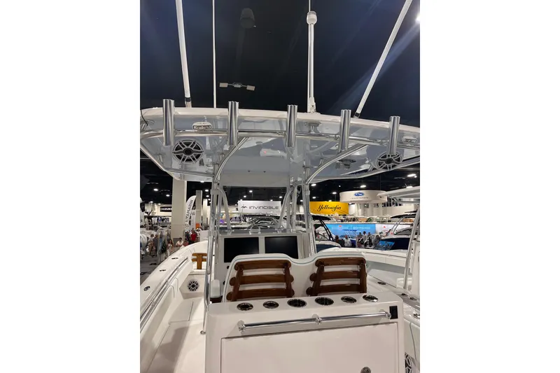 Slide: The Image of 2026 Contender 35 ST boat interior at a marine exhibition, showcasing helm and seating area. - 2