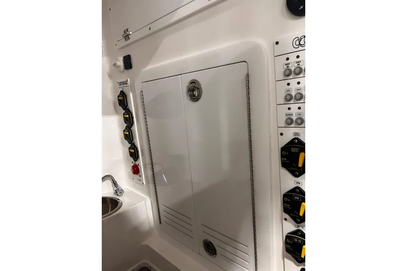 Slide: The Image of 2026 Contender 35 ST boat control panel with switches and storage compartment. - 9