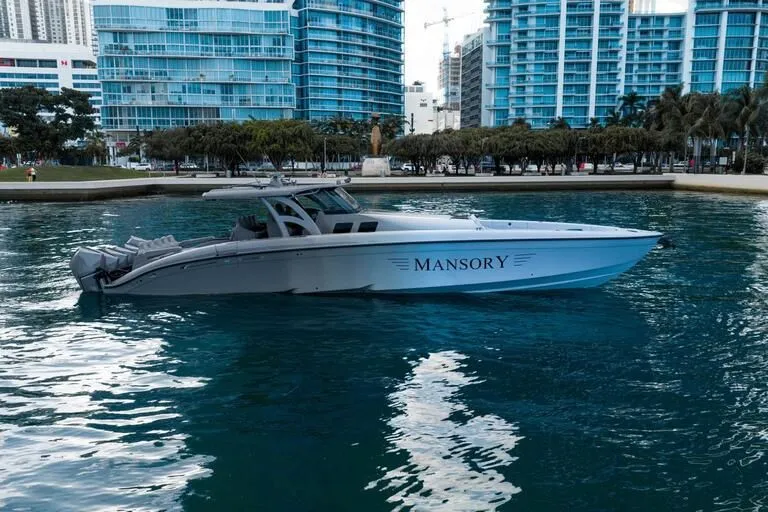 Slide: The Image of Luxury 2026 Midnight Express 52' Vitesse boat on urban waterfront with skyscrapers. - 11