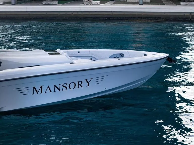 Slide: The Image of 2026 Midnight Express 52' Vitesse boat on water, featuring "Mansory" branding. - 13