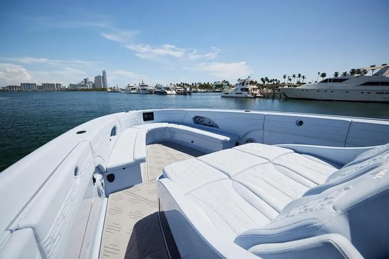 Slide: The Image of Luxurious 2026 Midnight Express 52' Vitesse yacht with spacious seating, docked in a sunny marina. - 16