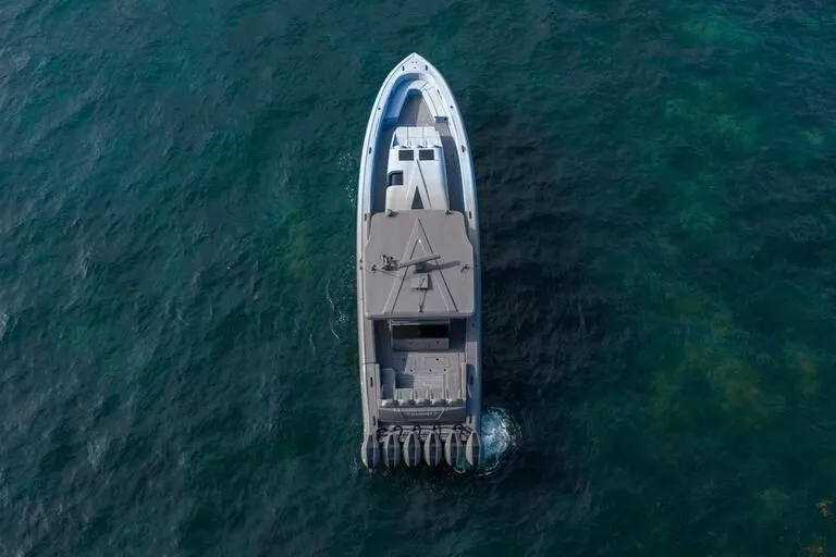 Slide: The Image of Aerial view of 2026 Midnight Express 52' Vitesse yacht cruising on clear blue water. - 7