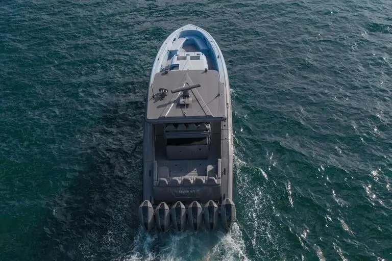 Slide: The Image of 2026 Midnight Express 52' Vitesse yacht cruising on open water, aerial view. - 9
