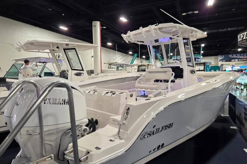 Slide: The Image of 2026 Sailfish 252 CC boat displayed indoors with Yamaha engine. - 11