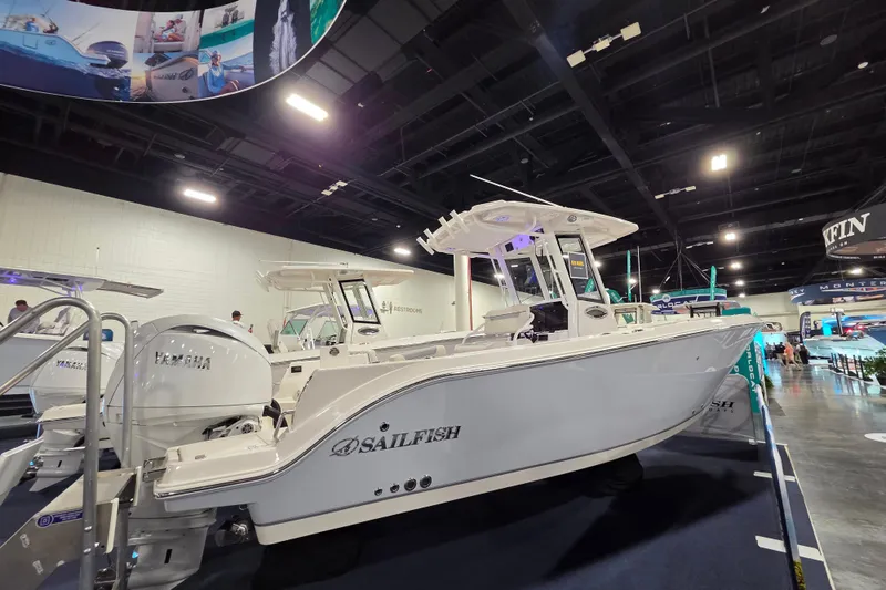 Slide: The Image of 2026 Sailfish 252 CC boat displayed indoors with Yamaha engines. - 12