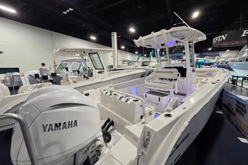 Slide: The Image of 2026 Sailfish 252 CC boat with Yamaha engine displayed at an indoor boat show. - 17