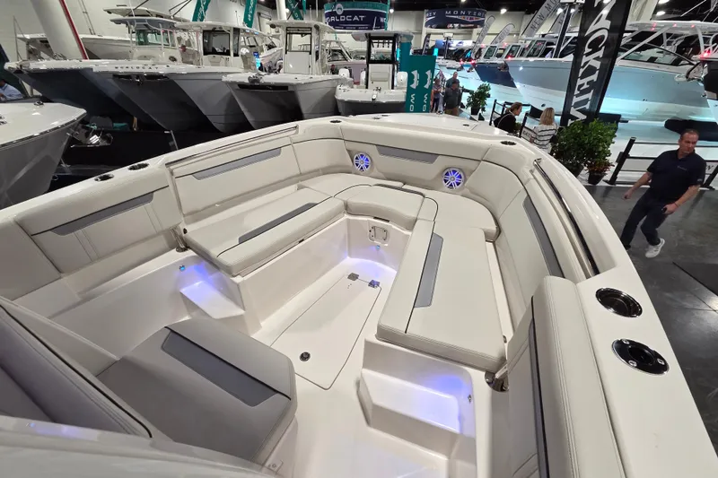Slide: The Image of 2026 Sailfish 252 CC boat interior with spacious seating and modern design at a boat show. - 24