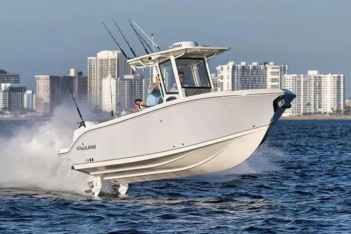Slide: The Image of Manufacturer Provided Image: 2026 Sailfish 252 CC boat cruising on water with city skyline in background. - 4