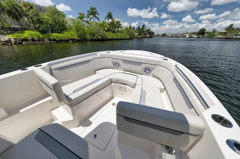 Slide: The Image of Manufacturer Provided Image: 2026 Sailfish 252 CC boat interior with spacious seating, set against a scenic waterway backdrop. - 5