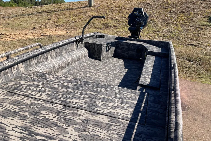 Slide: The Image of 2026 Havoc MSTC boat with camouflage interior, parked on grassy terrain. - 3