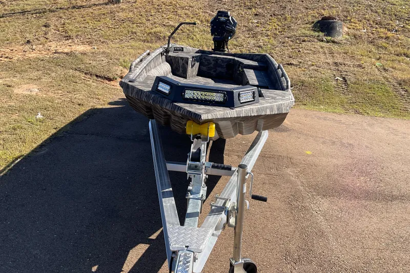 Slide: The Image of 2026 Havoc MSTC boat on trailer, parked on a sunny day. - 4