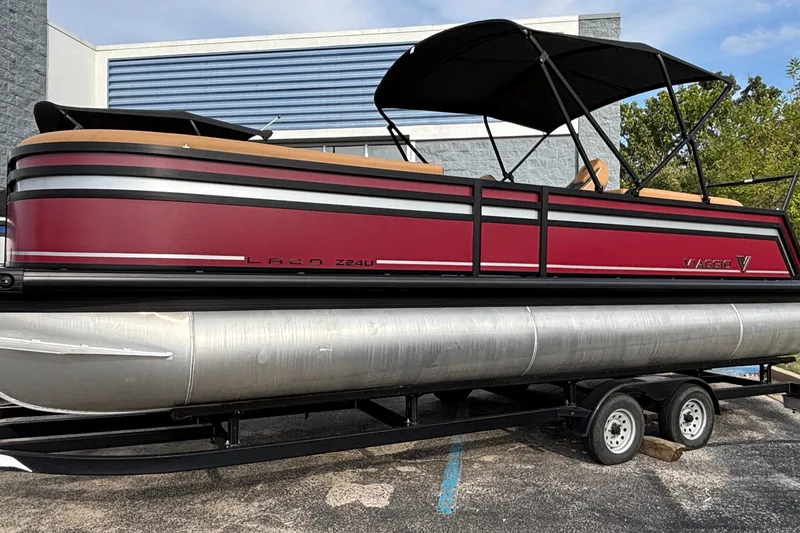 The Image of 2026 Viaggio Z24U pontoon boat on trailer, featuring red and black design. - 0