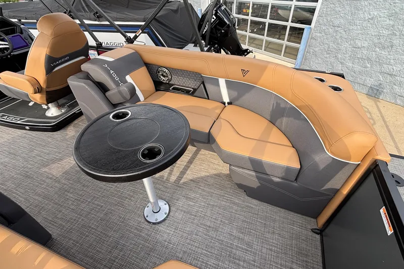 Slide: The Image of 2026 Viaggio Z24U boat interior with tan and gray seating, round table, and cup holders. - 7