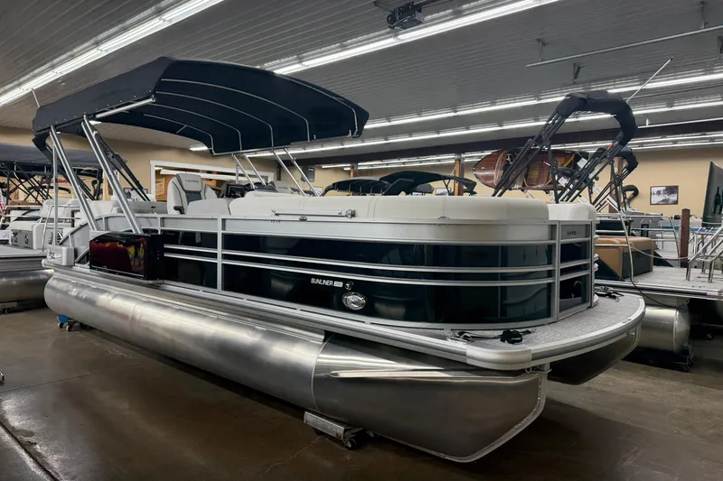 The Image of 2025 Harris Sunliner 230 pontoon boat with canopy in showroom setting. - 1