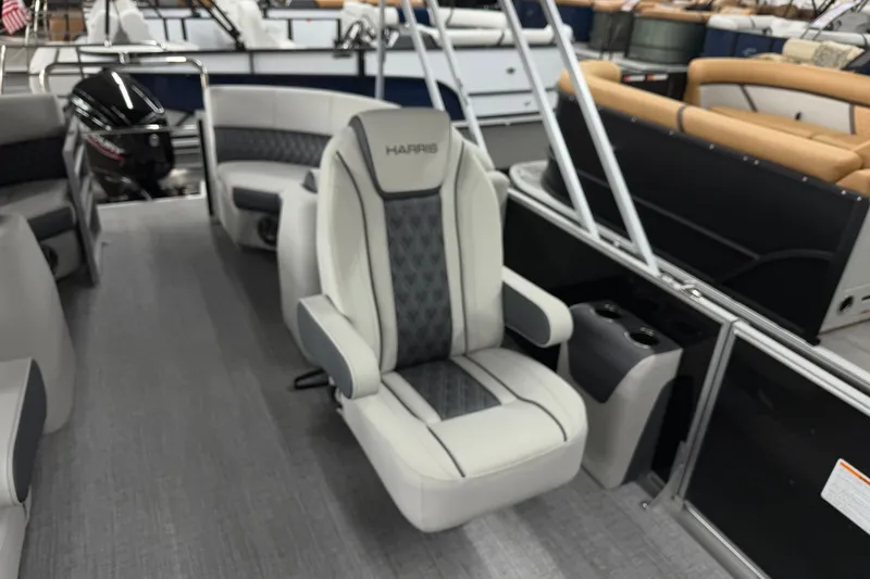 Slide: The Image of 2025 Harris Sunliner 230 boat interior with plush seating and modern design. - 10