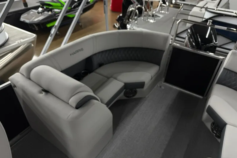 Slide: The Image of 2025 Harris Sunliner 230 pontoon boat interior with plush seating and modern design. - 12