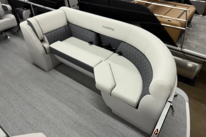 Slide: The Image of 2025 Harris Sunliner 230 boat interior with plush seating and modern design. - 3