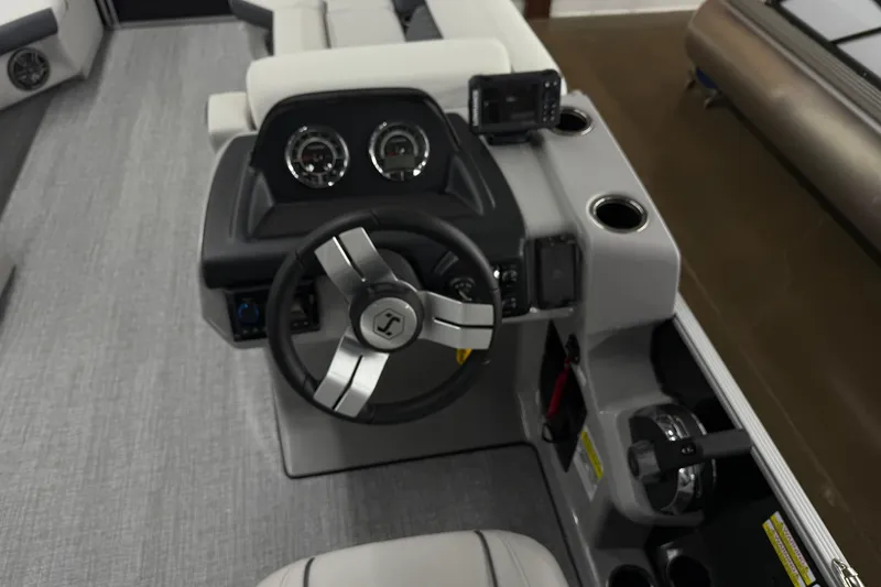 Slide: The Image of 2025 Harris Sunliner 230 boat dashboard with steering wheel and gauges. - 7