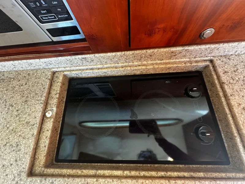 Slide: The Image of Built-in stovetop on 2006 Chris-Craft 43 Roamer yacht kitchen counter. - 26