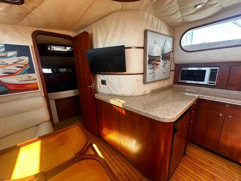 Slide: The Image of Luxurious interior of 2006 Chris-Craft 43 Roamer yacht with modern kitchen and cozy seating. - 29