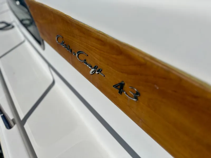 Slide: The Image of Close-up of 2006 Chris-Craft 43 Roamer boat nameplate on wooden panel. - 44